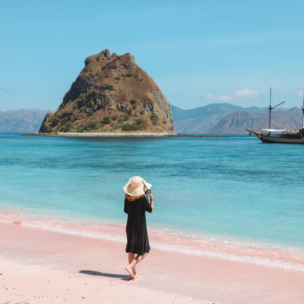 woman-on-vacation-on-pink-sandy-beach-2025-01-27-22-46-26-utc